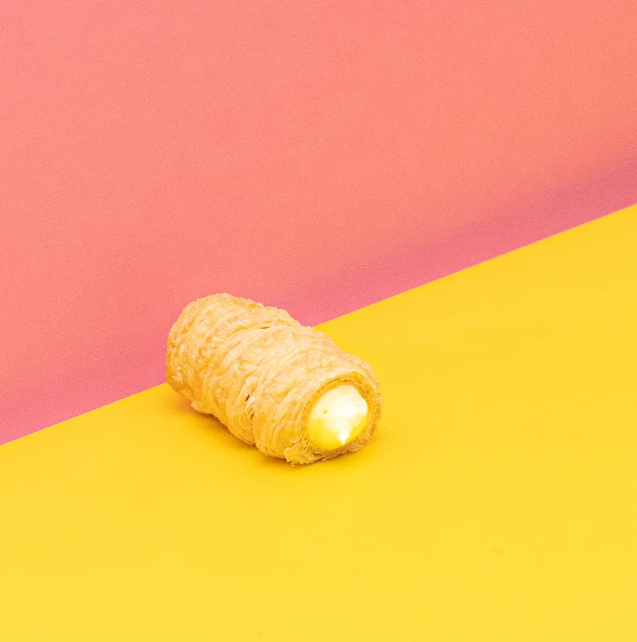 HOLY CANNOLI-NO — A crisp Italian pastry filled with silky custard, inspired by the comfort of a classic egg tart but finished with Sugar Daddy flair. Golden, creamy, and made to disappear in two bites.