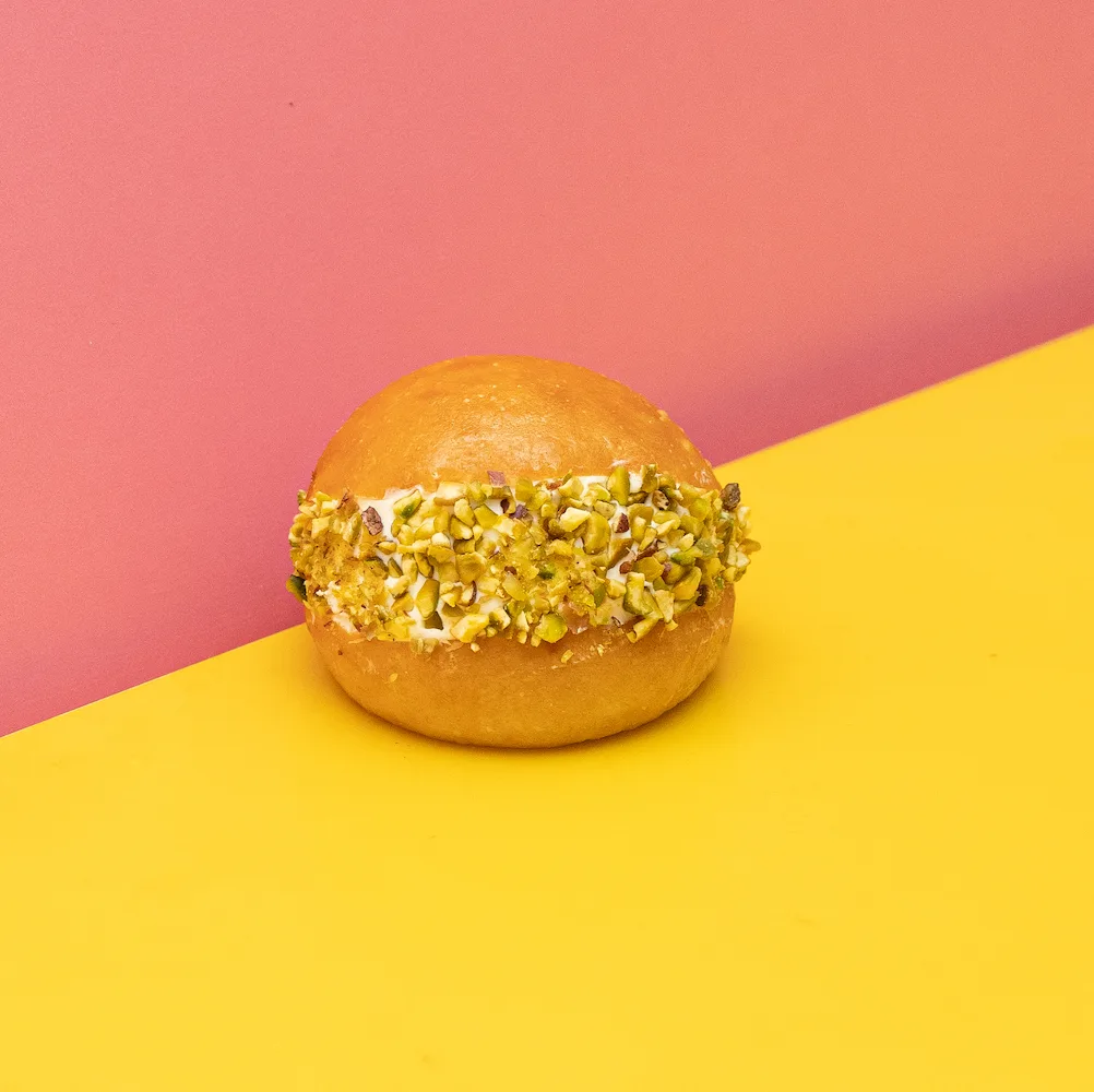 SDHK Maritozzo Pistachio — A soft Italian bun filled with rich pistachio custard, fresh whipped cream, and finished with pistachio crumbs. Creamy, nutty, and dressed for attention.